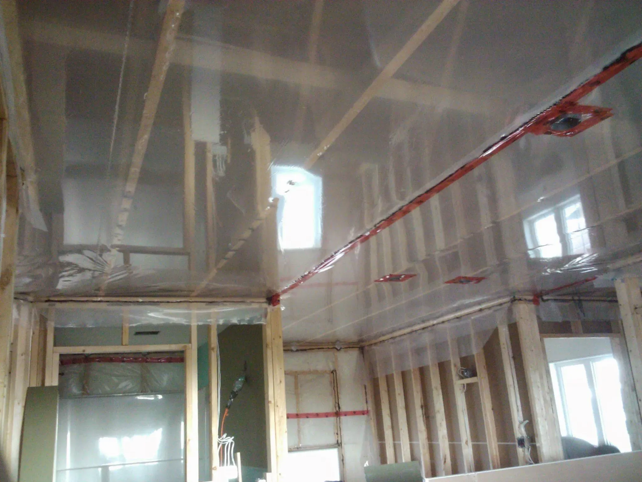 Soundproofing and drywall work in progress on a ceiling